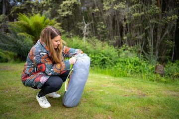 gril going camping with a tent in the bush. women hiking and camping in australia