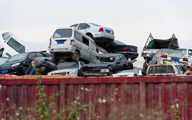 A pile of abandoned cars on junkyard