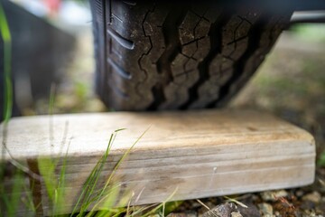 tyre blocks stuck behind a wheel, for a trailer in a park for camping