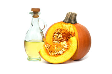 Pumpkin oil in decanter and fresh pumpkin with seeds
