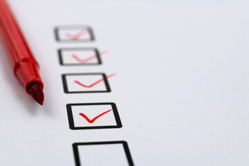 Red pen marking on checklist sheet