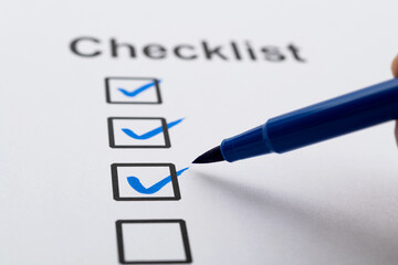 Blue pen marking on checklist sheet