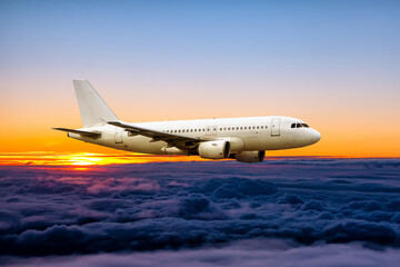 Fototapeta na wymiar White passenger airplane fly in the sunrise sky