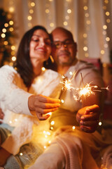 Happy interracial caucasian, black couple woman and man having fun, holding Bengali lights