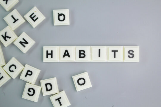 A mixture of letters of the alphabet with the word habits. the concept of self or a person's character
