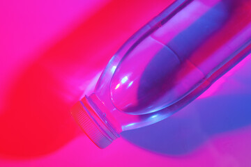Bottle of water on neon color background