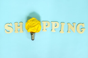Shopping tips and ideas concept. Bright yellow crumpled paper light bulb.