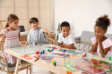 Little children during master class in Ebru painting at workshop