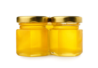 Jars with tasty honey on white background