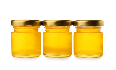 Jars with delicious honey on white background