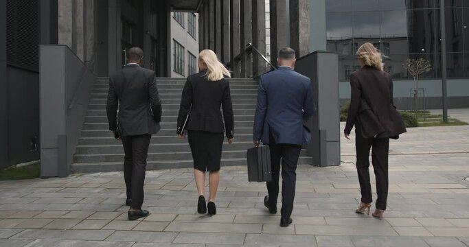 Business people walking outdoors near office building