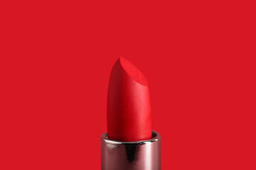 Beautiful red lipstick on color background, closeup
