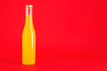 Bottle of drink on red background