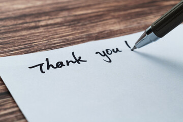 Writing thank you on white paper
