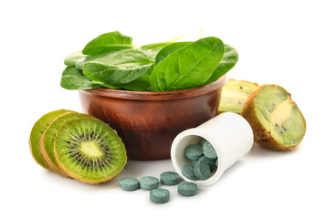 Healthy products and bottle of pills on white background