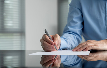 Businessman hand writing on paper