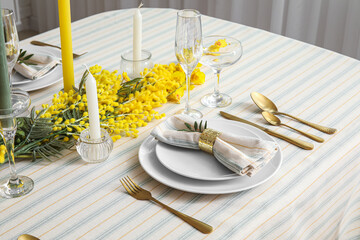 Plates with napkin and beautiful floral decor on served table