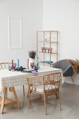 Beautiful table setting and lavender flowers in light room