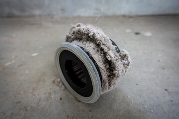 Household vacuum cleaner filter clogging up with dust, mite, hair, and animal fur after an extensive household cleaning : allergy, unhygienic concept