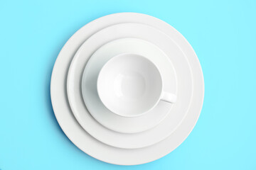 White cup with plates on blue background