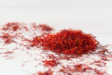 Dried saffron spices on a wooden table, selective focus.