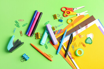 Set of different stationery on green background