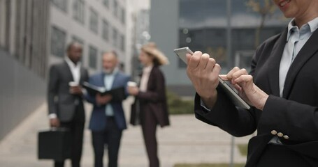 Caucasian elegant woman using digital tablet outdoors