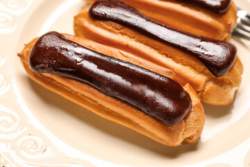 Plate of sweet chocolate eclairs, closeup