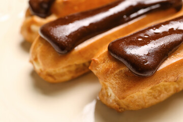 Plate of sweet chocolate eclairs, closeup