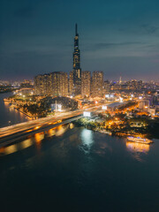 Aerial sunset view at Landmark 81 - it is a super tall skyscraper and Saigon bridge with development buildings along Saigon river, cityscape in the night