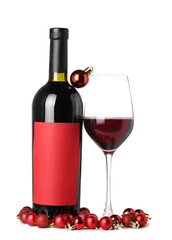 Bottle of wine with glass and Christmas balls on white background