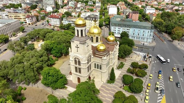 Cathedral in City center of Varna. Urban Landscape. Golden domes of the Assumption Cathedral. Aerial view. Drone flight around the Dormition of the Mother of God. Varna is the sea capital of Bulgaria.