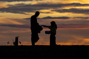 Asian Men and Women Gathering to Make Merit in the Morning, Light as a Silhouette