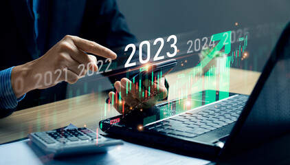 stock market trends for 2023, Businessman calculating financial data for long term investments. Analytical businessman planning business growth 2023 with future economic growth arrow graphic. strategy - obrazy, fototapety, plakaty