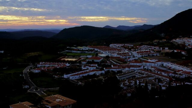 unique day to night  timelapse white town village on a wide spectacular angle during a sunrise rural spanish andalucia sierra jamones old white villages of the Sierra de Aracena, Huelva Jabugo Spain