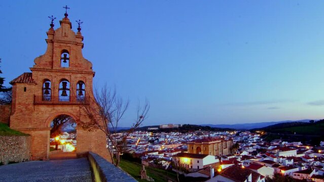 unique night to day timelapse church tower on a wide spectacular angle during a sunrise rural spanish andalucia sierra jamones old white villages of the Sierra de Aracena, Huelva Jabugo Spain