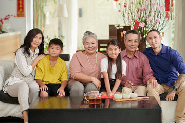 Portrait of happy big Asian family celebrating Tet at home