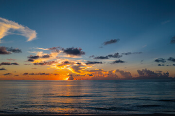 Cloudy sky on sea sunset, sunrise on ocean beach. Sunset landscape in the sky after sunset. Sunrise with clouds of different colors against the sky and sea.