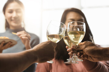 Group of happy colleagues having fun at a new year celebration or business success. Coworkers with diverse people at the office party