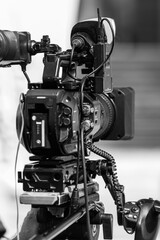 Camera at a media press conference publicity outdoors.