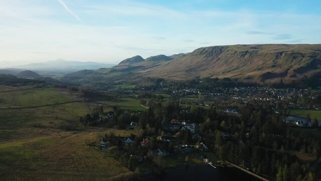 Aerial Flyover Approach to Strathblane Village, Stirlingshire. Drone Shot Flying Towards the Campsie Fells and Dumgoyne