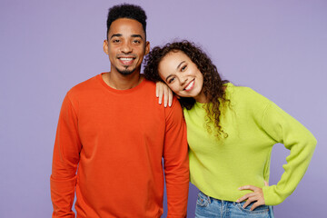 Fototapeta premium Young smiling happy couple two friends family man woman of African American ethnicity wear casual clothes together put head on shoulder look camera isolated on pastel plain light purple background.