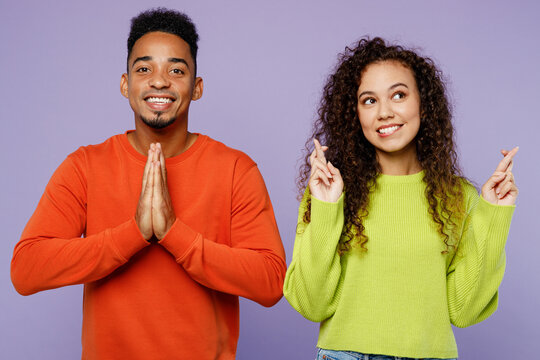 Young Couple Two Friends Family Man Woman Of African American Ethnicity Wear Casual Clothes Together Wait Special Moment, Keeping Fingers Crossed Pray Isolated On Pastel Plain Light Purple Background.