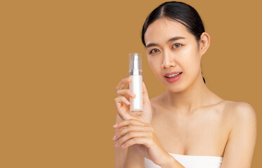 Beauty asian women portrait face with skin care healthy and skin holding and showing bottle of serum beige color background.