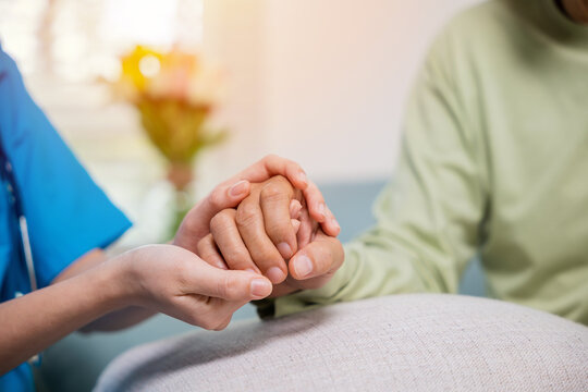 Closeup hand. Young woman helping hold hands offering her senior man, Caring nurse helping elderly old man care gets help from hospital, medical health care, International Day for the Elderly concept