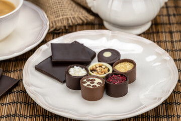 Set of antique porcelain coffee cup with sugar bowl and delicious chocolate candies
