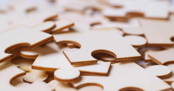 Close up Shot rotation of wooden jigsaw puzzle pieces on white background, Business concept