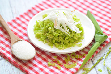 Green rice sweet with ears of rice pandan leaf, Thai dessert - pounded unripe rice food rice flakes cereal with coconut and sugar, Food dessert or snacks - Khao Mao name in Thailand