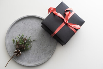 Christmas giftbox on cement round tray