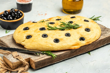 homemade focaccia bread baking with seasonings on a wooden board. top view. place for text